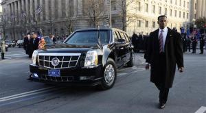U.S. Secret Service officers escort the presidential limousine down Pennsylvania Avenue enroute to the White House